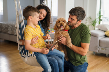 Happy family leisure. Cheerful mother, father and son having fun together on weekend at home