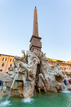 Rome, Italy - 02 November 2012: View of the Fountain of Four Rivers, its sculpted figures gleaming against the ancient obelisk, water cascading into the basin in Piazza Navona.