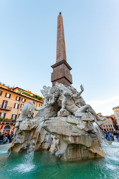 Rome, Italy - 02 November 2012: View of the Fountain of Four Rivers with the Obelisco Agonale piercing the Roman sky, its travertine figures glistening under the soft light.