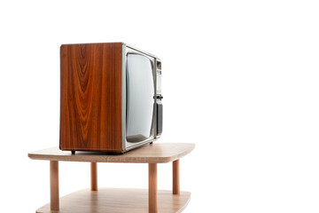 Side view. Retro old TV on wooden table on white background, vintage television in the room.