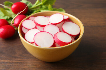 Fresh ripe radishes on wooden table, closeup