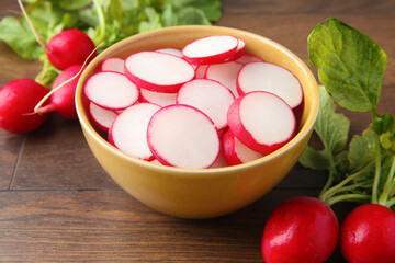 Fresh ripe radishes on wooden table, closeup