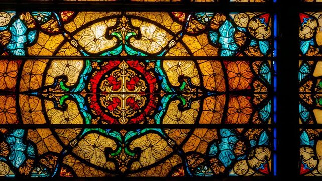 Camera focusing on cross motif panning right in church revealing amber designs and lead-framing - Powered by Adobe