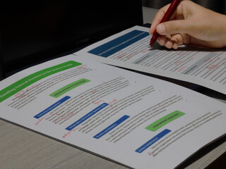 proofreading paperwork on table