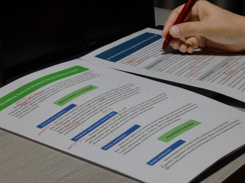 proofreading paperwork on table