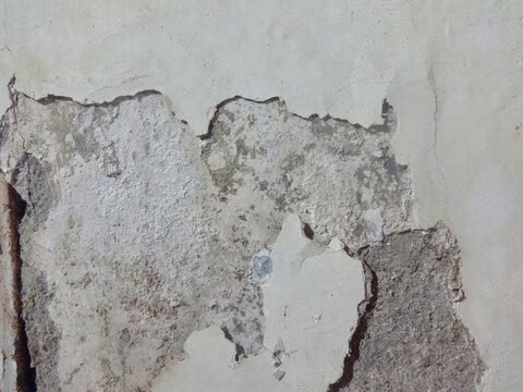 walls with peeling paint and some plaster damaged by moisture