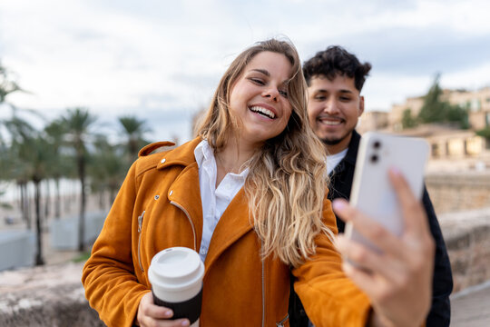 Young generation z couple taking selfie outdoors
