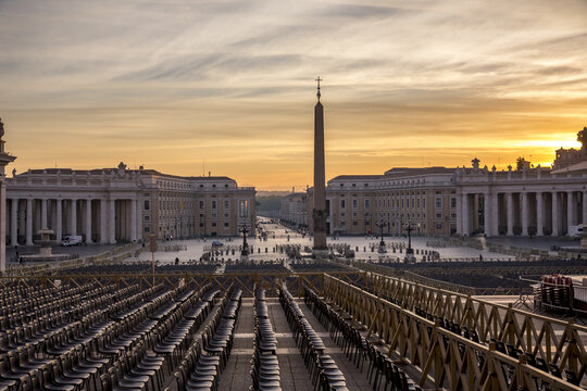 View of St. Peter's Square bathed in the warm glow of sunrise, its colonnades embracing the obelisk, a serene moment frozen in time, Rome, Lazio, Italy.