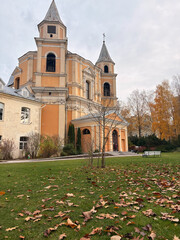 Historic European Church in Autumn Landscape