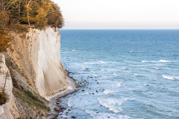 White chalk cliffs above the blue sea in sunlight. Baltic coast from above.