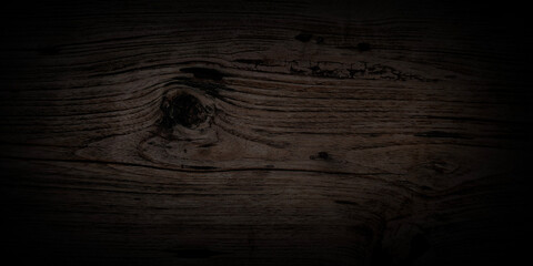 Fototapeta premium Horizontal close-up smooth dark wood featuring rich. Strong, soft vignette that fades edges into absolute black creating moody sophisticated and luxurious atmosphere elegant websites digital vintage