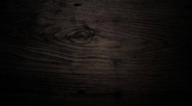 Horizontal close-up smooth dark wood featuring rich. Strong, soft vignette that fades edges into absolute black creating moody sophisticated and luxurious atmosphere elegant websites digital vintage