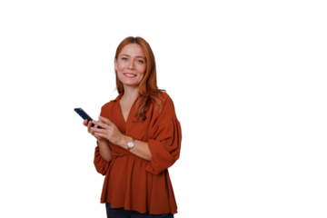 Redhead woman smiling, holding and using a smartphone, connecting through technology, looking at camera. Transparent background