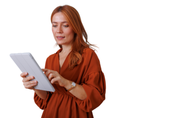 Woman with red hair holding tablet, browsing internet, using modern mobile technology, transparent background