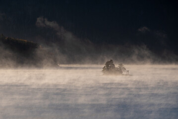 Benten Island on Lake Shikaribetsu emerging in the morning mist