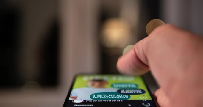 A close-up of a hand and fingers performing a rapid, constant scrolling movement on a smartphone's touchscreen. This represents the fast consumption of information or content.