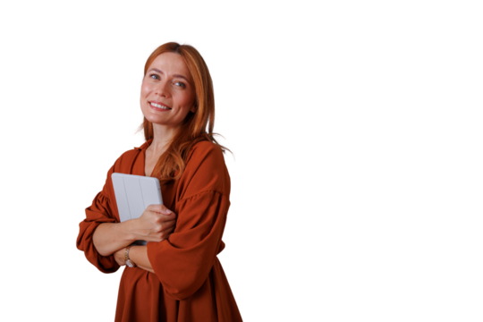 Professional woman with red hair smiling, holding tablet, demonstrating confidence and expertise