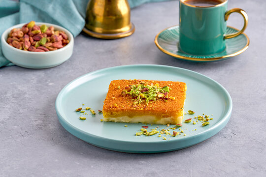       Middle eastern sweets kunefe; kunafa; kadayif with pistachio and coffee