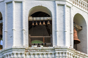 View on brass bells with ropes in the belfry of Epiphany Cathedral in Yeniseysk, Russia. Automatic bell ringing system for an Orthodox church © Вера Тихонова