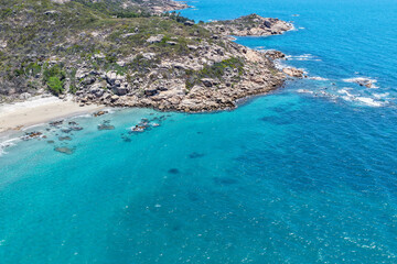 An aerial view of Rose Bay in Bowen, Queensland, reveals a stunning tropical coastline with...