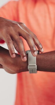 Man, hands or smart watch in studio for exercise, tracking heart rate or fitness progress app. Person, scroll or check time for workout results, wellness and monitor step counter on white background.