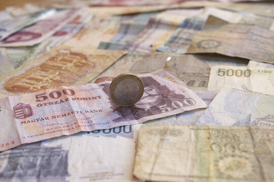 one euro coin on mixed international banknotes