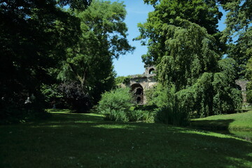 Lush green park landscape with old stone ruins