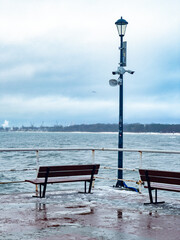 Two lonely benches on a pier in winter