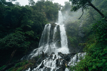Waterfalls in the natural rainforest during the rainy season and mist from rain and waterfalls