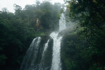Waterfalls in the natural rainforest during the rainy season and mist from rain and waterfalls
