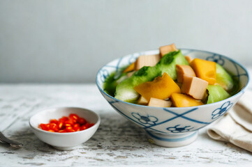 Fresh tofu and vegetable salad with red pepper garnish