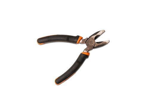 Close-up of rusty combination pliers with black and orange handles on white background, showing details of the old metal texture