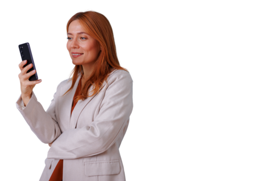 Redhead woman smiling, looking at smartphone, communicating with mobile device, transparent background