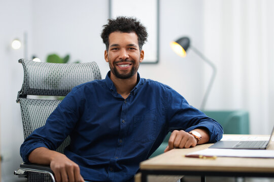 Portrait of man at table in office