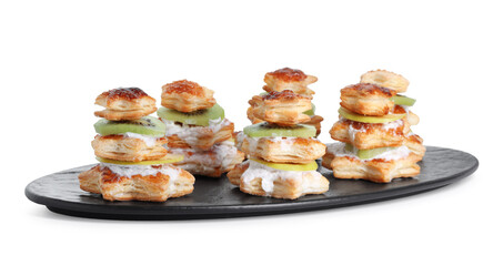 Sweet snacks made of puff pastry and slices of kiwi isolated on white. Christmas food