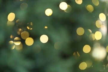 Beautiful blurred Christmas lights on color background, closeup. Bokeh effect