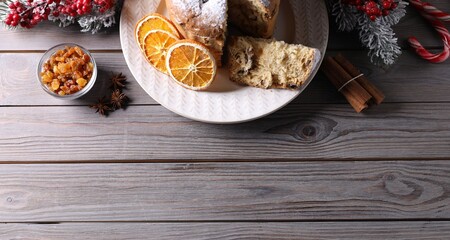 Christmas food. Delicious Panettone cake and festive decor on wooden table, flat lay. Space for text