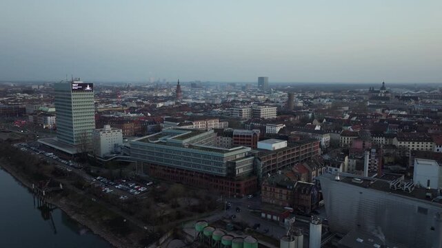 Aerial view of Mannheim, Germany showcasing the city's architecture including MVV Hochhaus and skyline as the sun sets