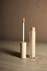 Beige concealer bottle for face makeup and beauty care.