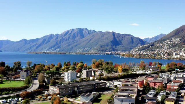 Aerial footage taken with a drone over Lake Maggiore in the canton of Ticino, Switzerland. A sunny autumn day with very clear skies.