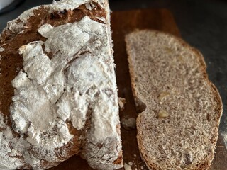 freshly baked sourdough bread sliced on wooden cutting board, directly above