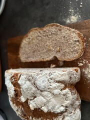 freshly baked sourdough bread sliced on wooden cutting board, directly above