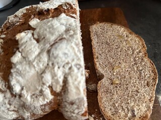 freshly baked sourdough bread sliced on wooden cutting board, directly above