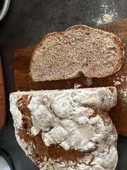 freshly baked sourdough bread sliced on wooden cutting board, directly above