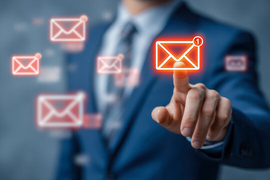 Businessman in suit interacting with holographic digital envelope icons representing new messages and email notifications in a futuristic communication concept