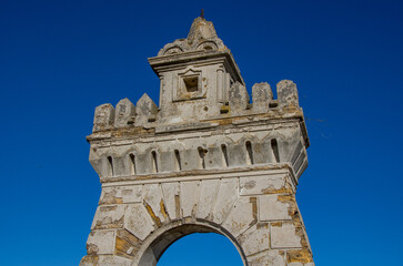 Crumbling Stone Archway Tower Detail Against Deep Blue Sky