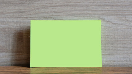 Mockup, Copy Space, Green paper mock up on wood background.