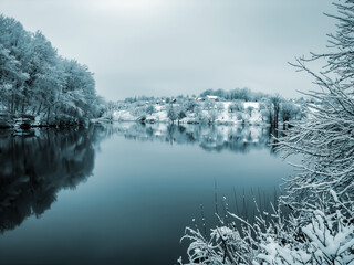 A pond in the countryside after heavy snowfall.