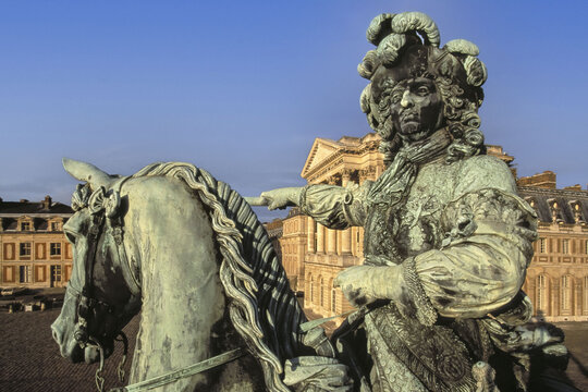 Versailles, France - 04 November 2025: View of the equestrian statue of Louis XIV, a bronze figure commanding attention against the backdrop of the grand Palace of Versailles.