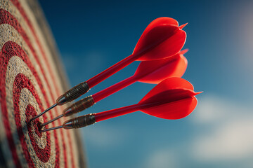 Three red darts perfectly hitting the bullseye on a textured target — vivid symbol of precision, focus, achievement and success in competition or leisure